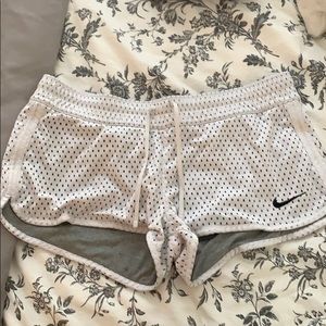 Nike large shorts with white perforated pattern